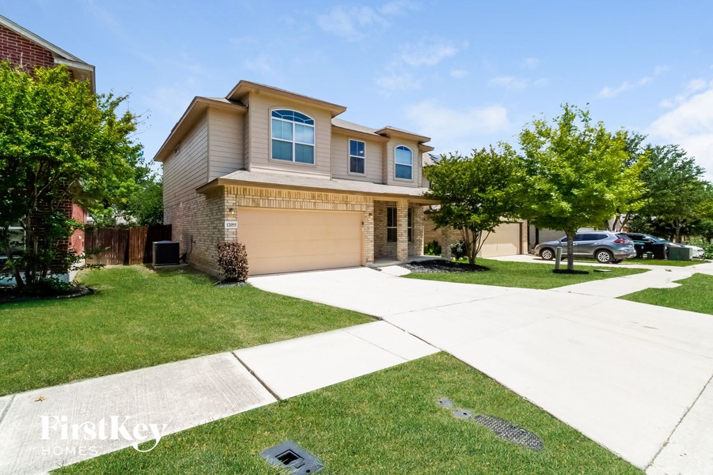 a large house with a driveway and lawn