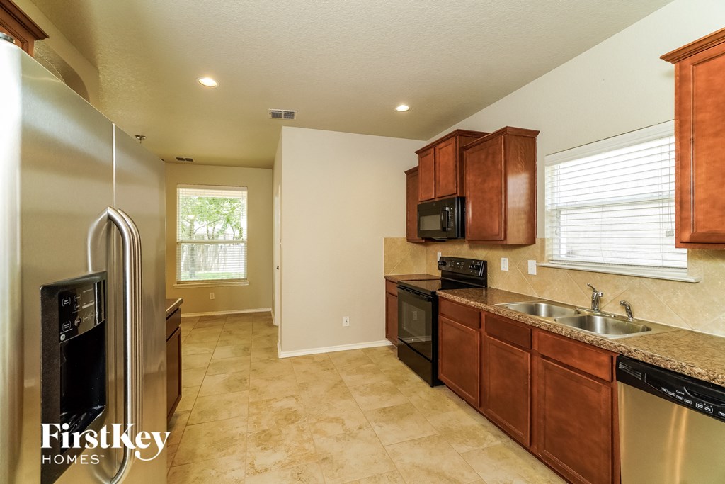 a kitchen with stainless steel appliances and wooden cabinets