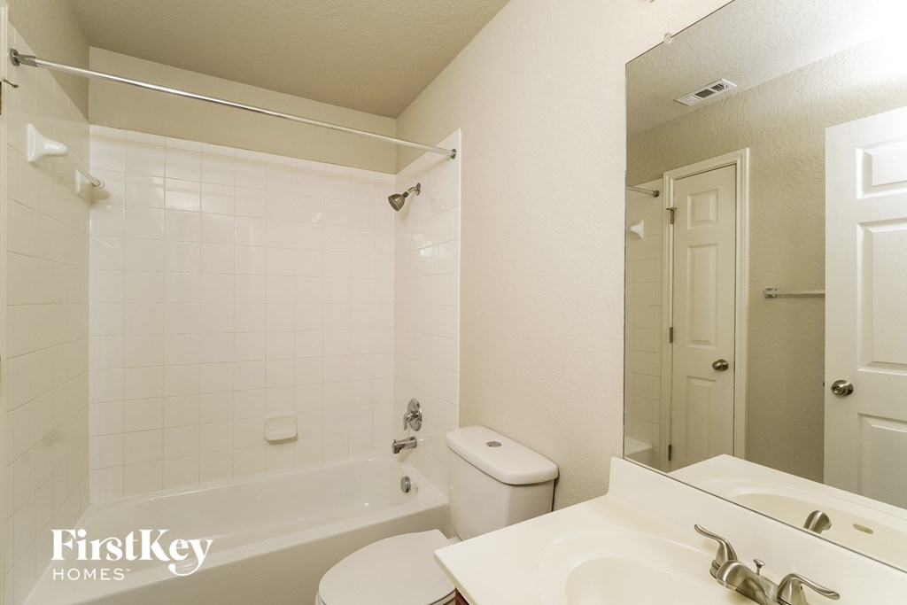 a bathroom with a sink toilet and a tub