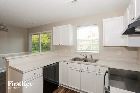 A kitchen with a sink and a window.