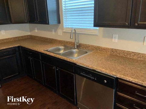 a kitchen with a granite counter top and a sink