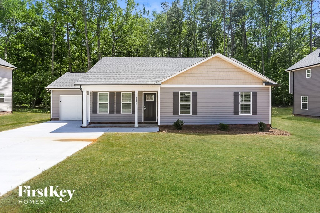 a home with a lawn and a driveway