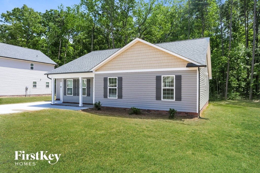 the front view of a home with a lawn and a driveway