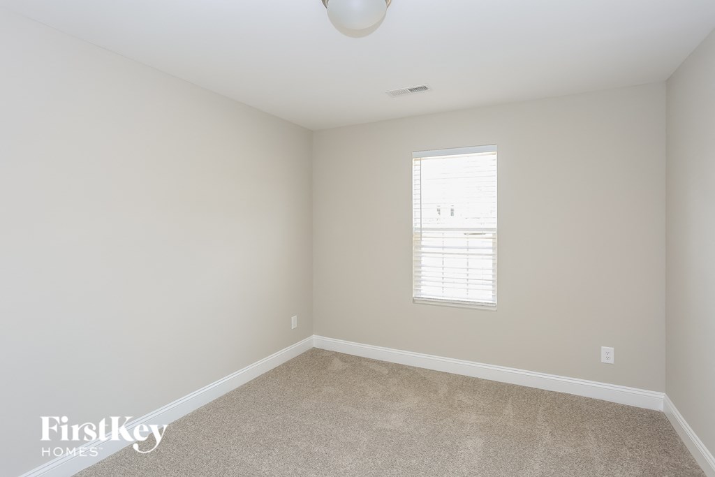 a small room with white walls and a window