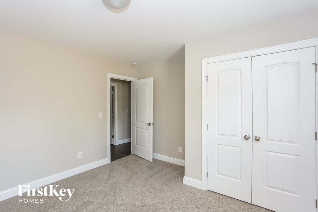 a bedroom with two closets and a door to a hallway