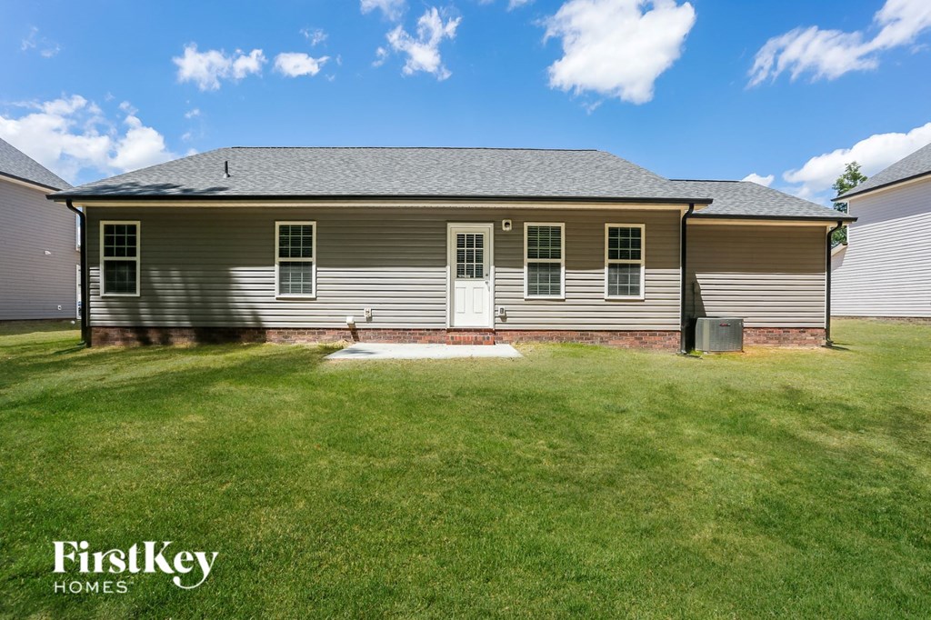 the front of a house with a lawn and a driveway
