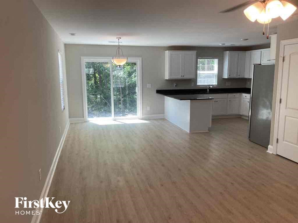 A kitchen with wooden floors and a FirstKey Homes logo.
