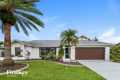 a white house with palm trees in front of it