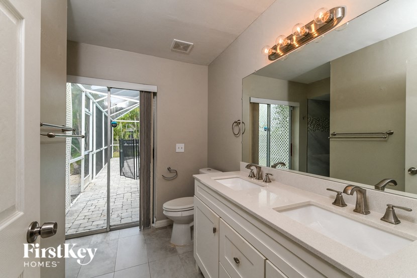 a bathroom with a sink and a toilet and a mirror