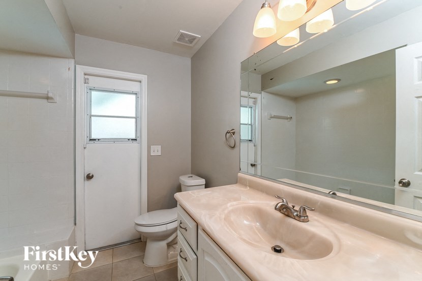a bathroom with a sink and a toilet and a mirror