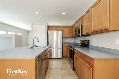 a kitchen with wooden cabinets and stainless steel appliances
