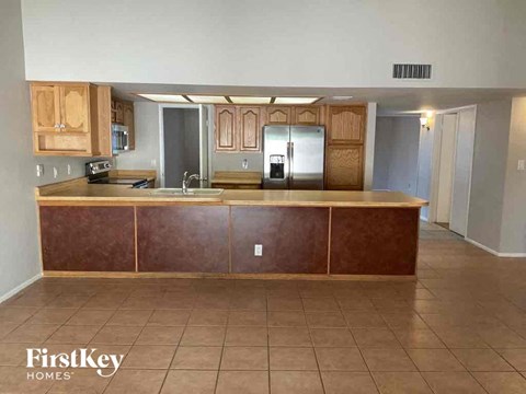 A kitchen with wooden cabinets and a brown counter.