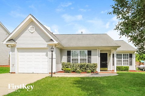 a white house with a lawn in front of it