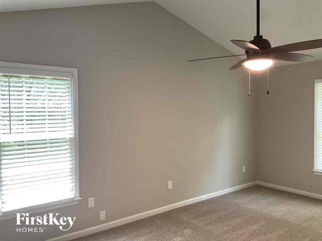 a living room with a ceiling fan and a window