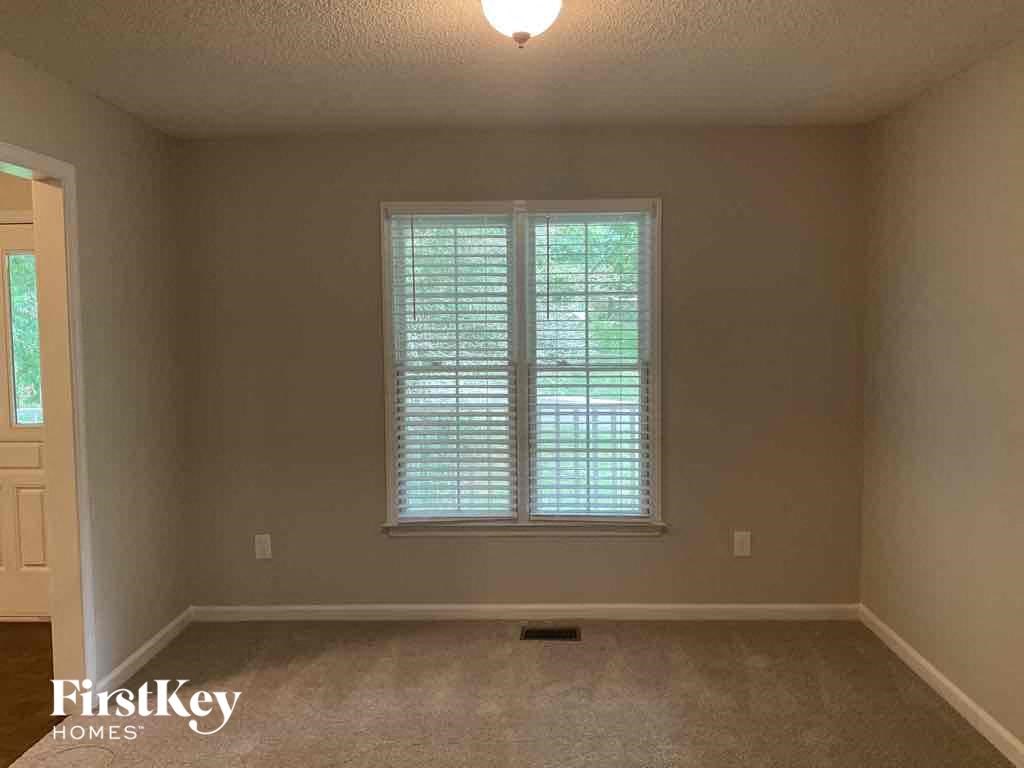 an empty room with a window and a door