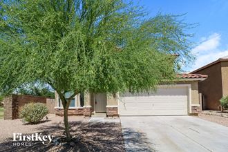 a large white garage door in front of a tree