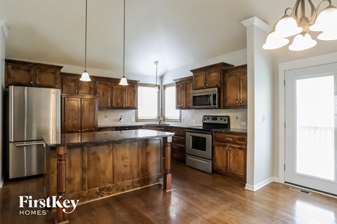 a kitchen with wooden cabinets and stainless steel appliances
