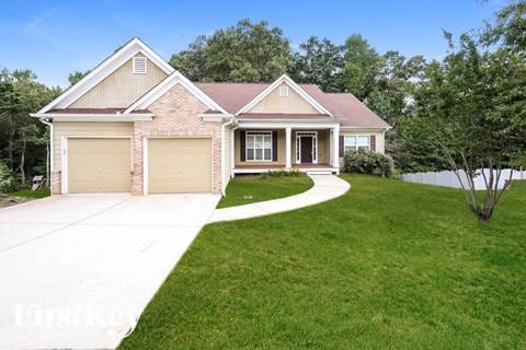 A house with a red roof and a garage door.