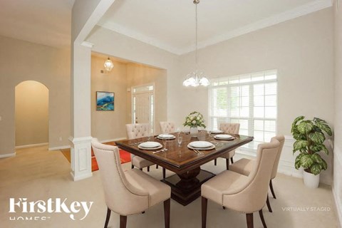 A dining room with a wooden table and chairs.