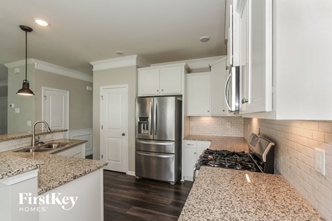 A kitchen with granite countertops and stainless steel appliances.