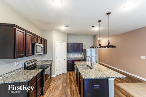 a kitchen with granite counter tops and stainless steel appliances