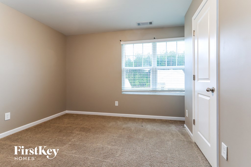 a empty room with a window and a door