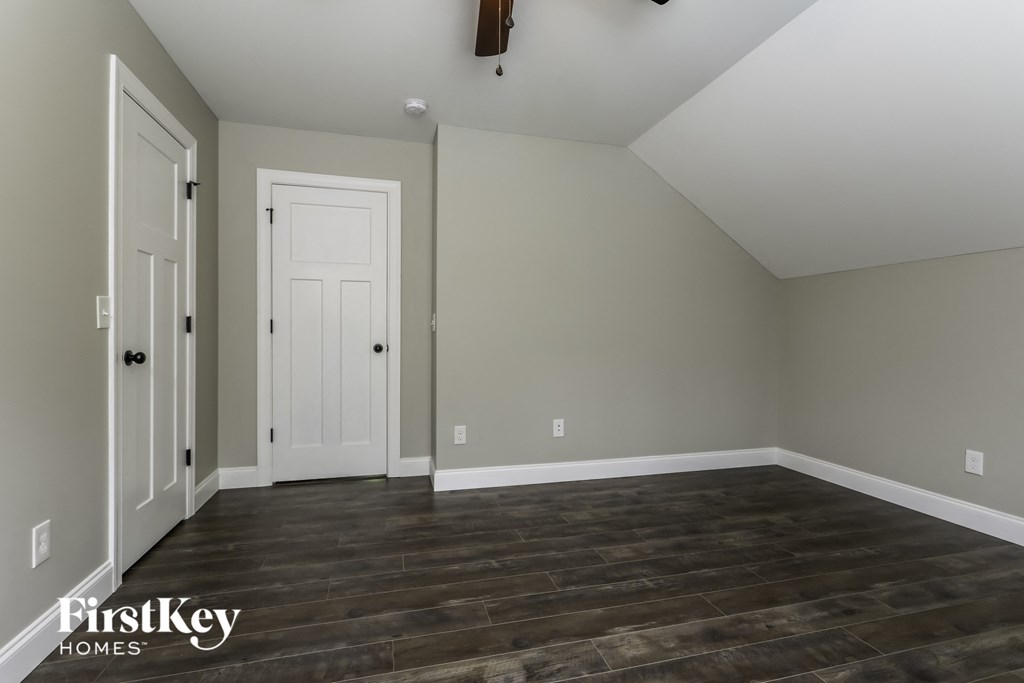 a living room with wood floors and a white door