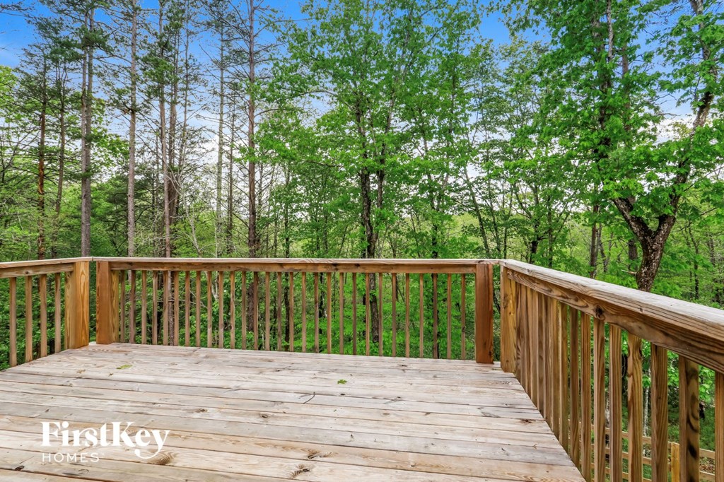 a wooden deck with trees in the background