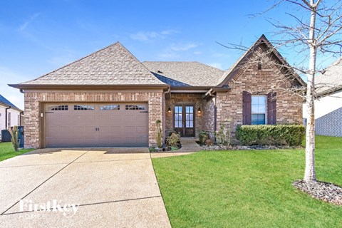 a house with a driveway and a garage door