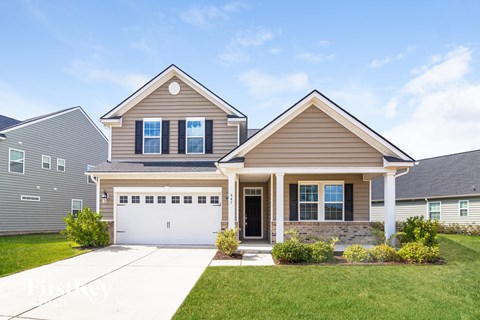 a brown house with a white garage door