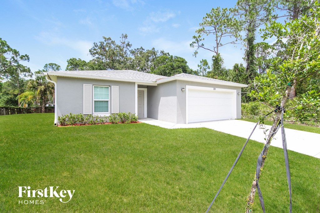 A house with a white garage door is for sale.