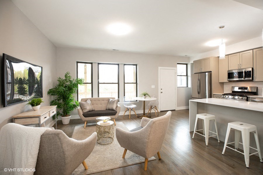 an open kitchen and living room with chairs and a table