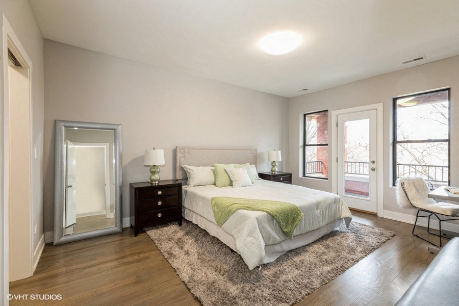 a bedroom with a bed and a door to a balcony