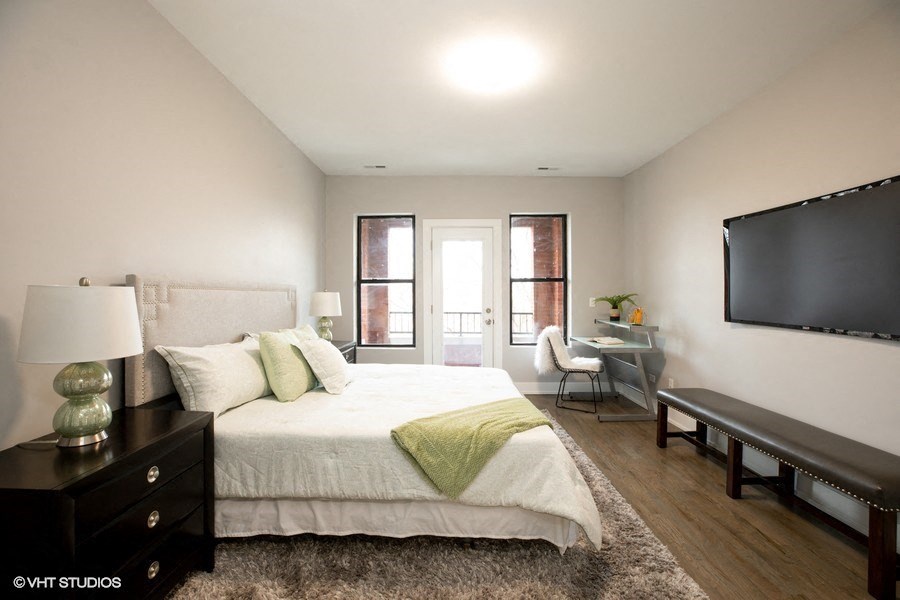 a bedroom with a large bed and a tv