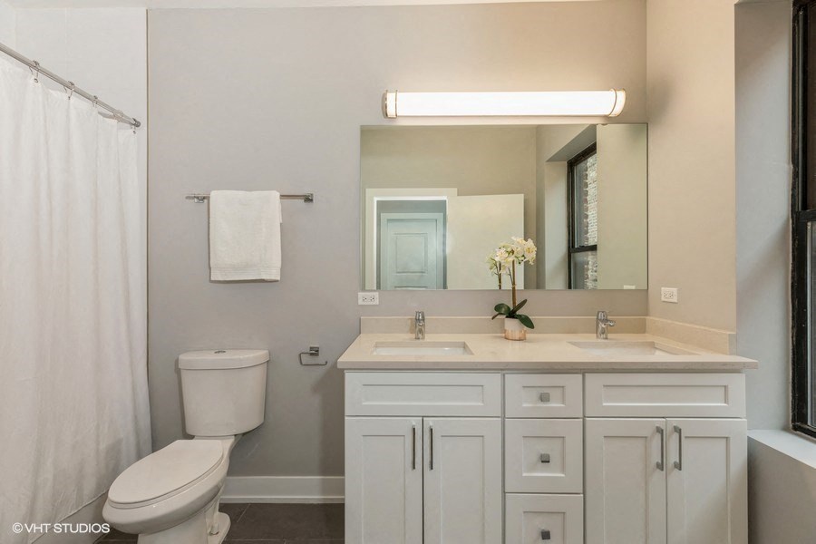a bathroom with a sink toilet and a mirror