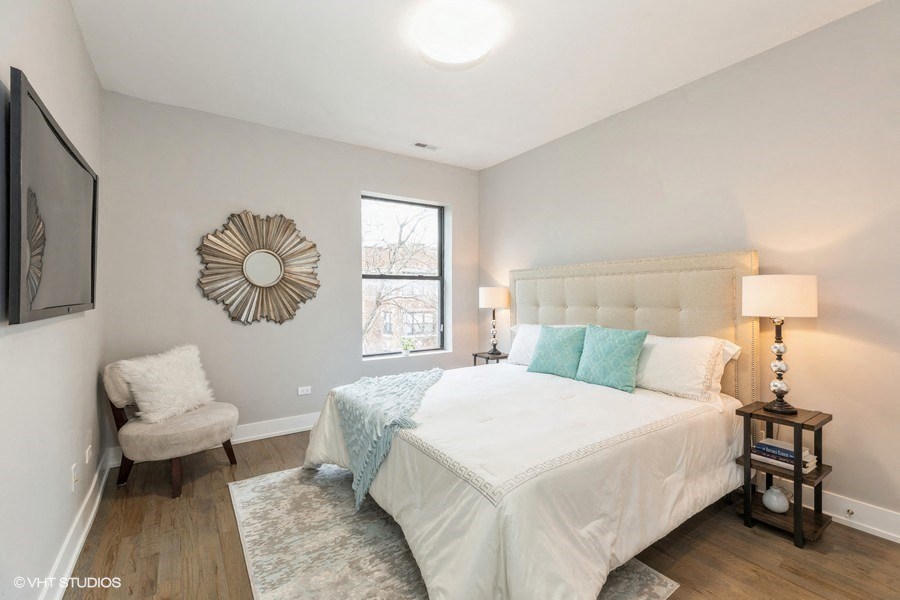 a bedroom with a large bed and a window