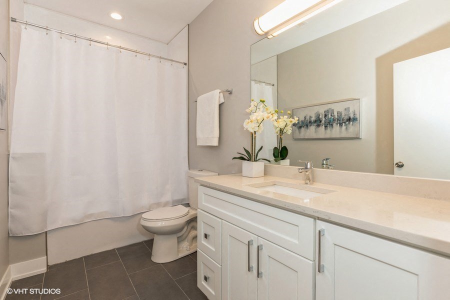 a white bathroom with a sink and a toilet