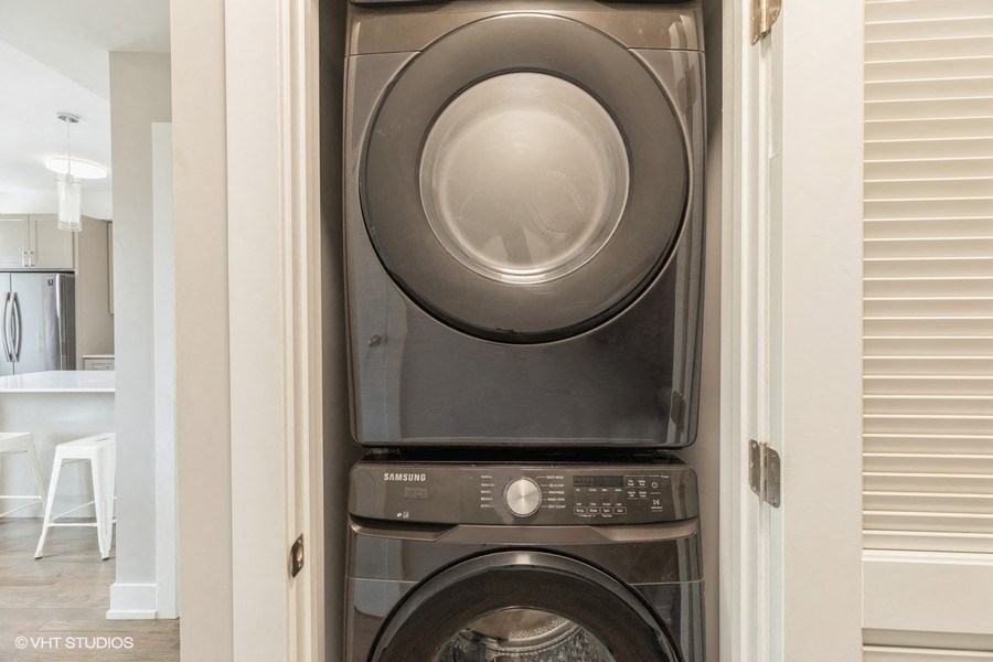 a stacked washing machine and dryer in a bathroom
