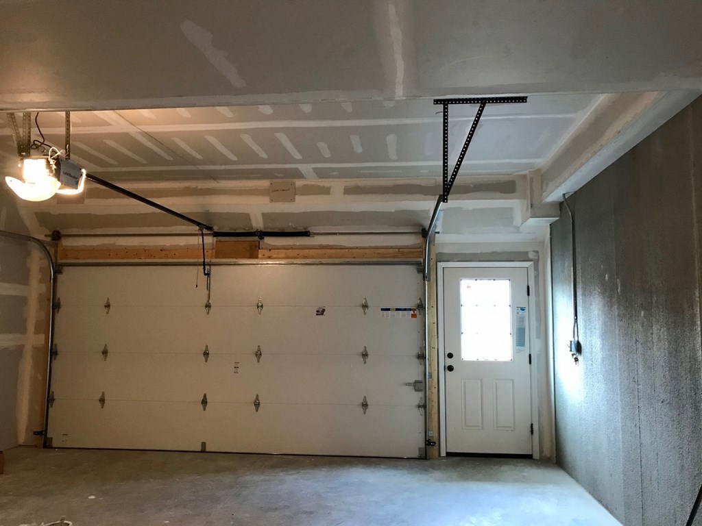the living room of a garage with a door