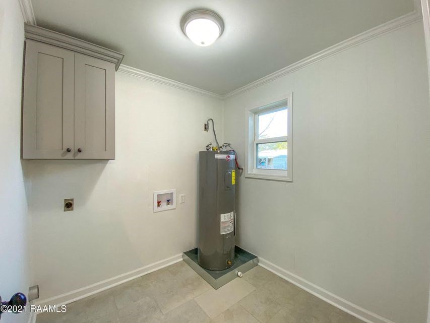 a white room with a water heater and a window