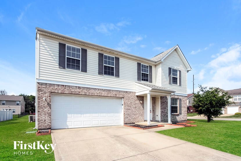 A two-story house with a garage is for sale.