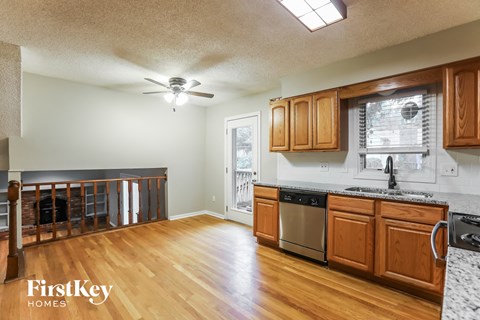 A kitchen with wooden cabinets and a stainless steel dishwasher.