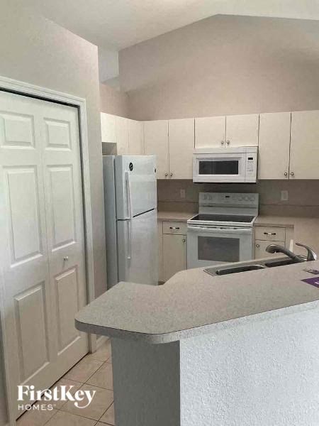 a kitchen with a stove microwave and refrigerator