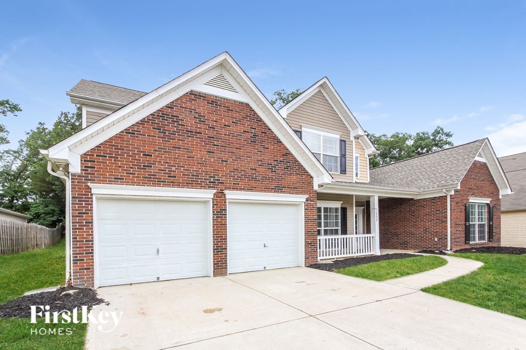 a brick house with a white garage door