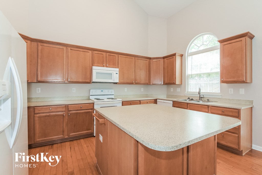 a kitchen with wooden cabinets and a white counter top