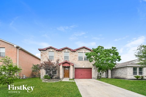 A house with a red garage door is for sale by FirstKey Homes.