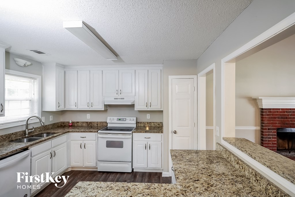 a white kitchen with white appliances and white cabinets