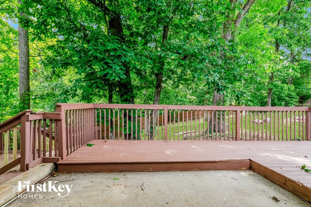 a wooden deck with trees in the background
