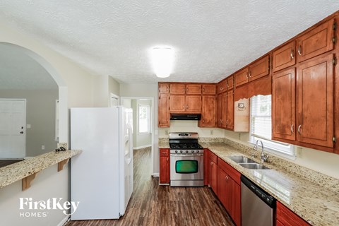 a kitchen with wooden cabinets and white appliances