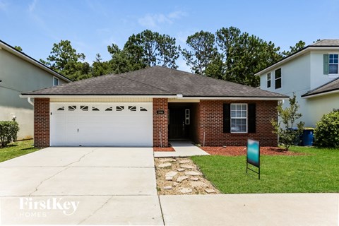 a small brick house with a white garage door